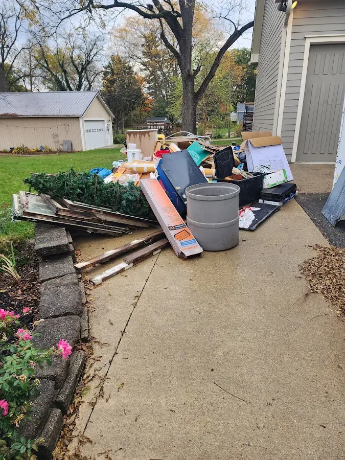 Dumpster being loaded with debris for Estate Cleanout Dumpster Rental in Kemp Mill